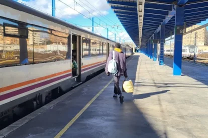 Un passatger es dirigeix a un tren de l’R14 cap a Vinaixa que ahir va sortir de l’estació de Lleida-Pirineus. - A. BATLLE