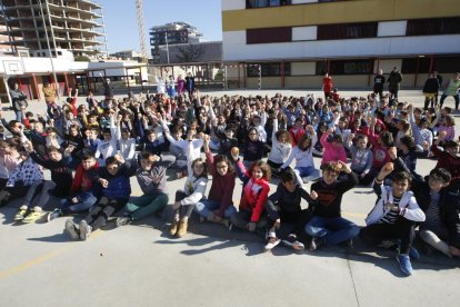 Alumnos del Frederic Godàs comiendo manzanas en el patio.