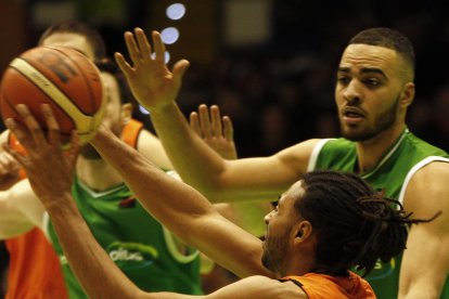 Obi Kyei intenta llançar a cistella davant de dos rivals.