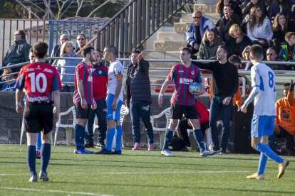 Dos jugadors es disputen el control de la pilota durant una acció del partit.