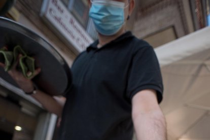 sensesotre. Dos persones dormen sota una passarel·la sobre riu Segre a Lleida mentre una tercera fa esport.