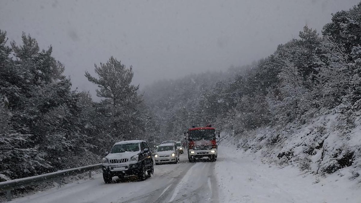 Un vehículo de Bomberos en la carretera cubierta de nieve en Sant Llorenç de Morunys.