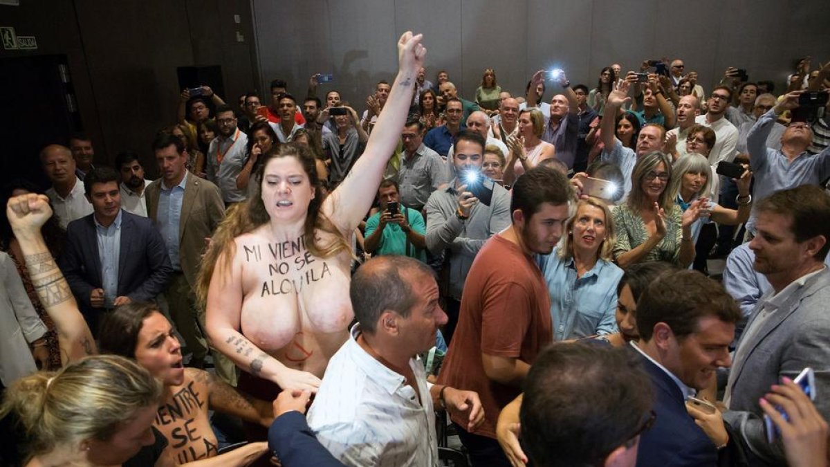 Protesta de Femen - Dos activistes del moviment Femen van irrompre ahir en l’acte que Ciutadans va organitzar a Màlaga i en què participava el número 1 del partit, Albert Rivera (a la part dreta de la foto). Les dos dones es van manifestar en  ...