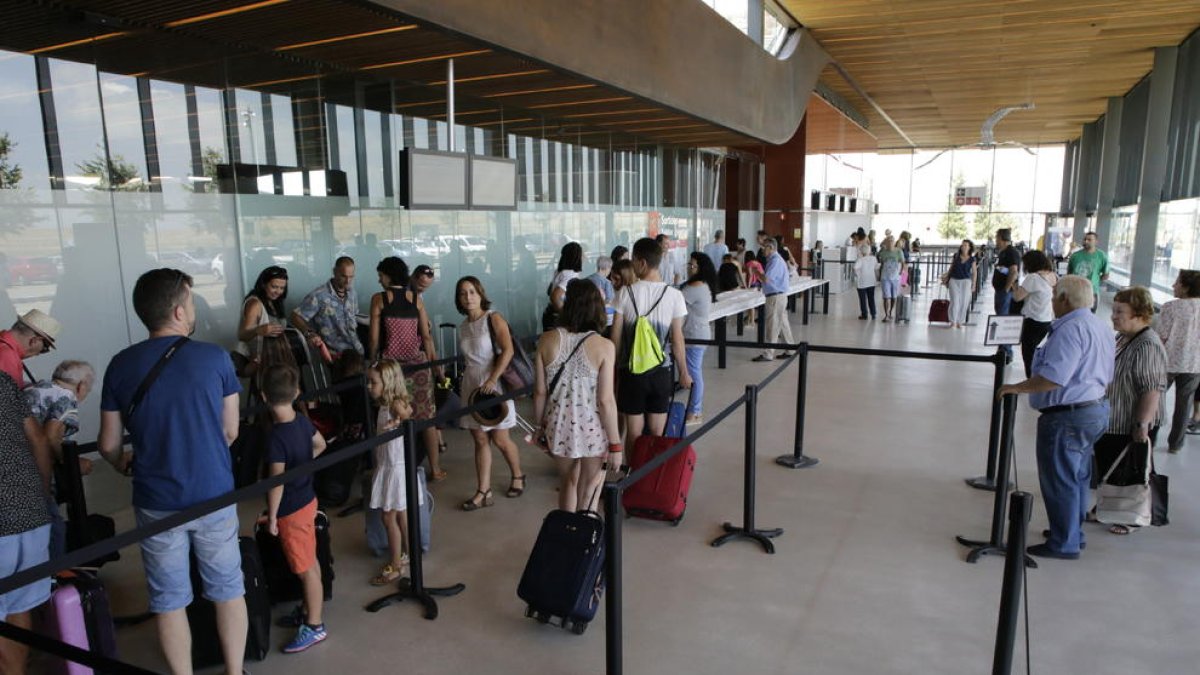 Viajeros en la terminal de Alguaire durante la primera jornada de los vuelos de verano a Ibiza y Menorca.