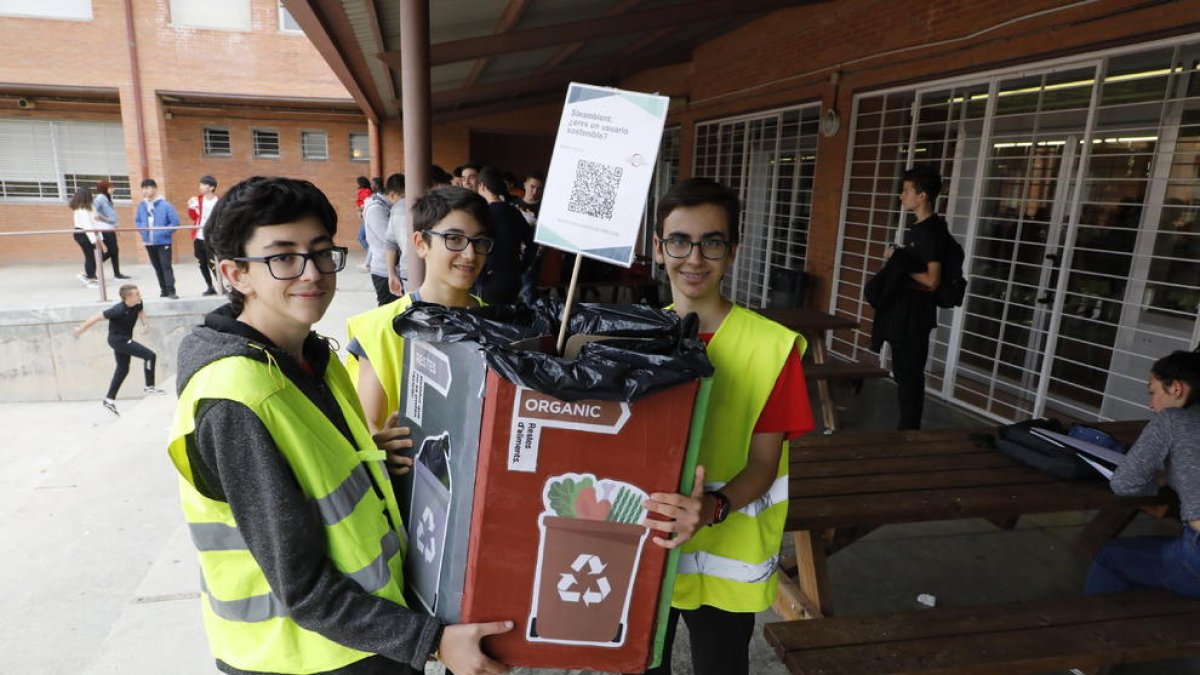 Alumnos transportan un punto de recogida a la hora del recreo para fomentar el reciclaje correcto de los residuos.