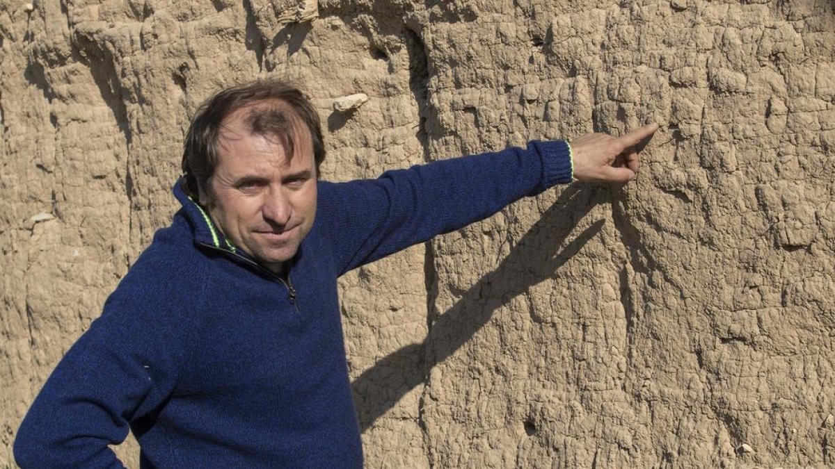 El historiador Miquel Torres, junto a un muro de tapia.