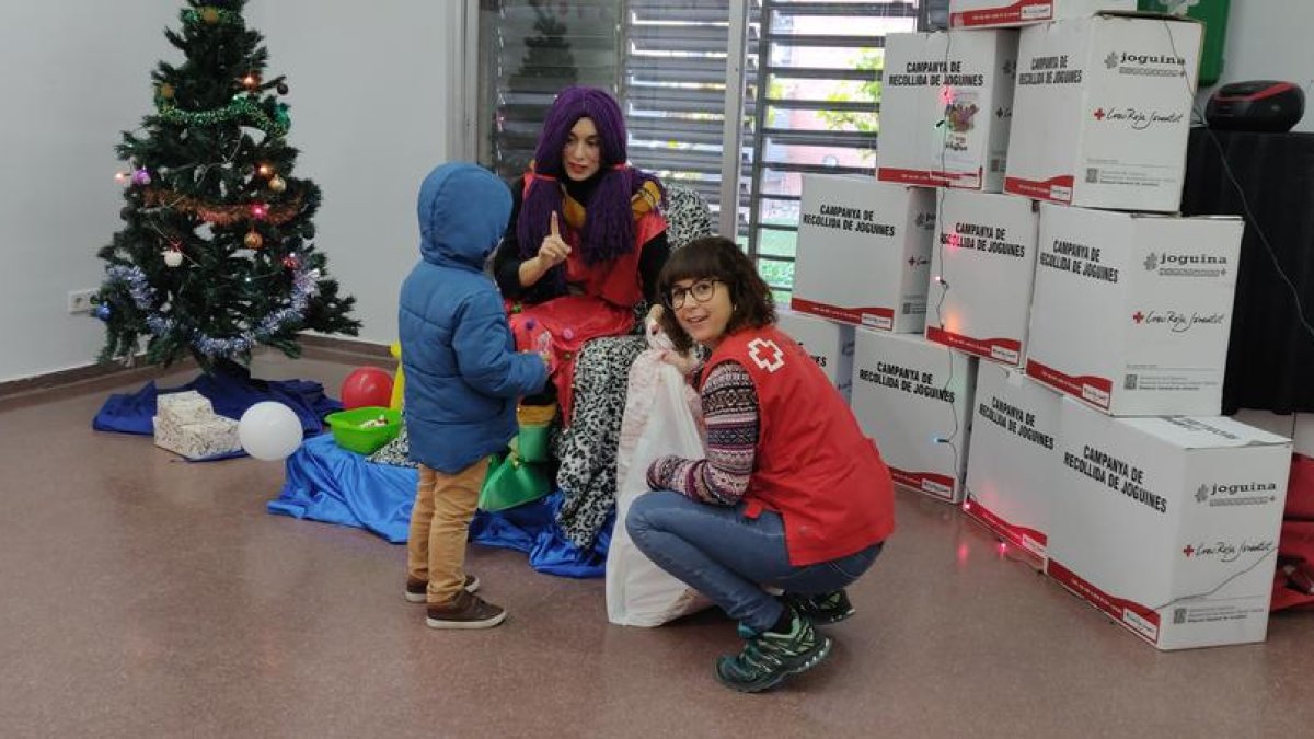 La Vermelleta de Creu Roja repartiendo los juguetes solidarios entre los más pequeños. 