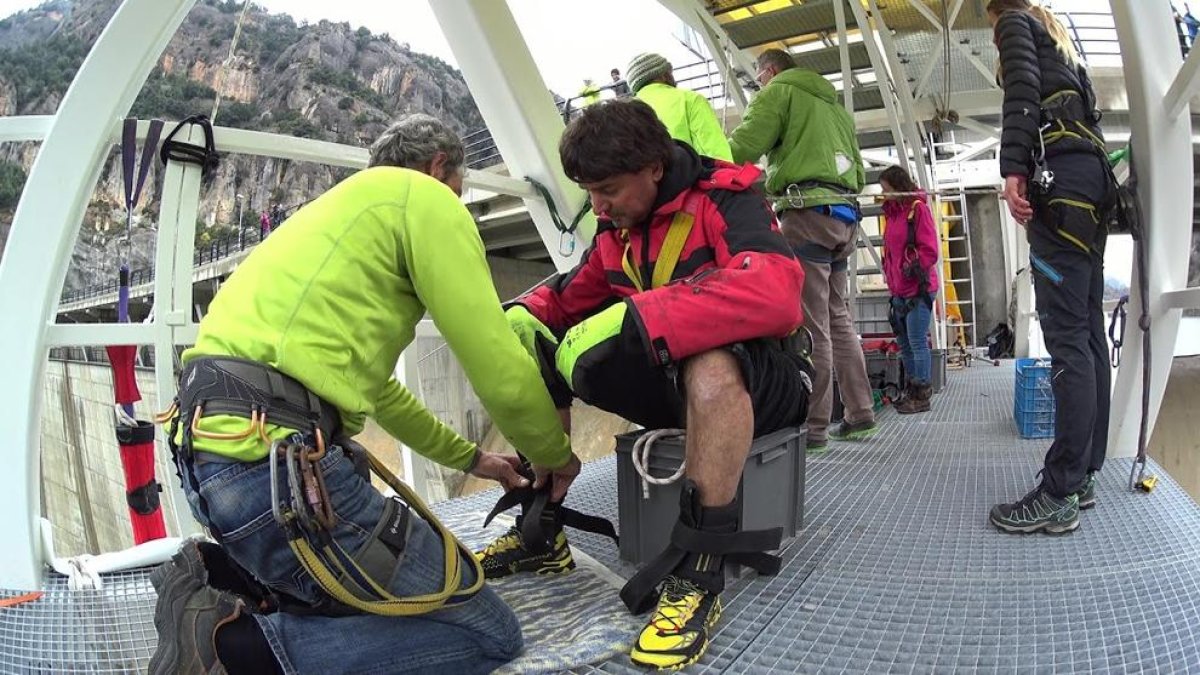 Els preparatius per saltar des de dalt de la presa de la Llosa en aquesta modalitat anomenada ‘bungee’ i un client a l’efectuar el salt.