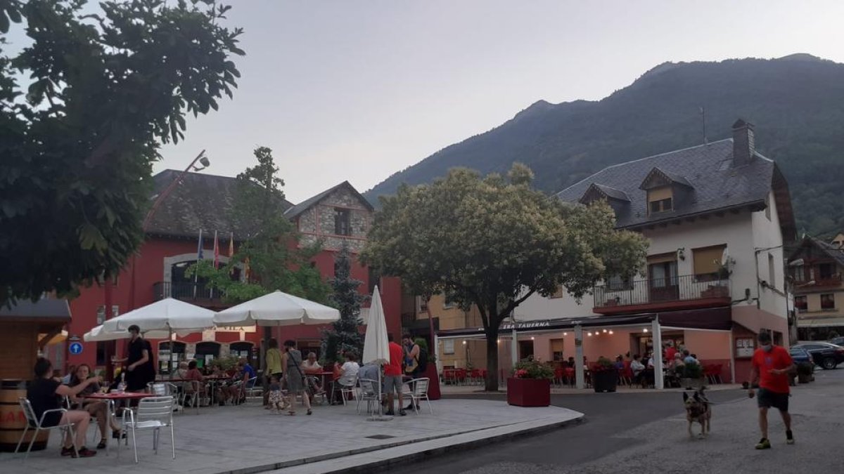 Persones passejant i consumint a les terrasses de bars de Les, que habitualment rep nombrosos veïns de França.