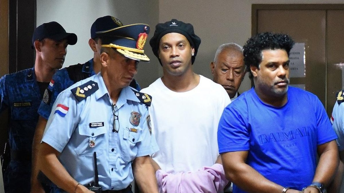 Ronaldinho oculta que està emmanillat amb un jersei a les mans.