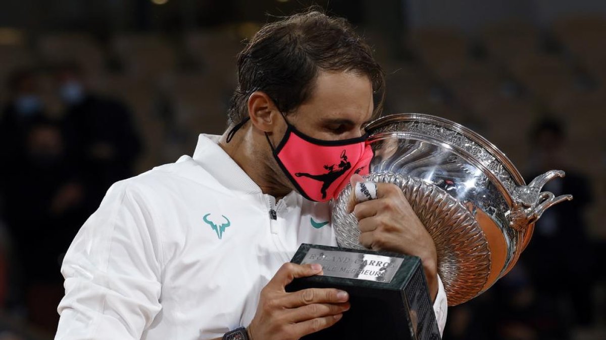 Nadal, con la mascarilla puesta, besa el trofeo de Roland Garros, el torneo con el que ha agrandado más su leyenda al conquistar trece títulos.