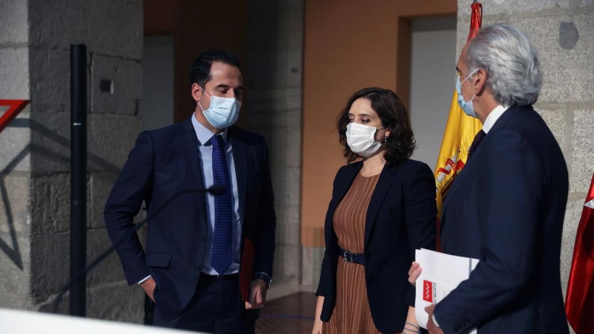 La presidenta madrileña, Isabel Díaz Ayuso, el vicepresidente madrileño, Ignacio Aguado (izda), y el consejero de Sanidad de Madrid, Enrique Ruiz, ofrecen una rueda de prensa para anunciar las restricciones de movilidad para hacer frente al coronavirus.