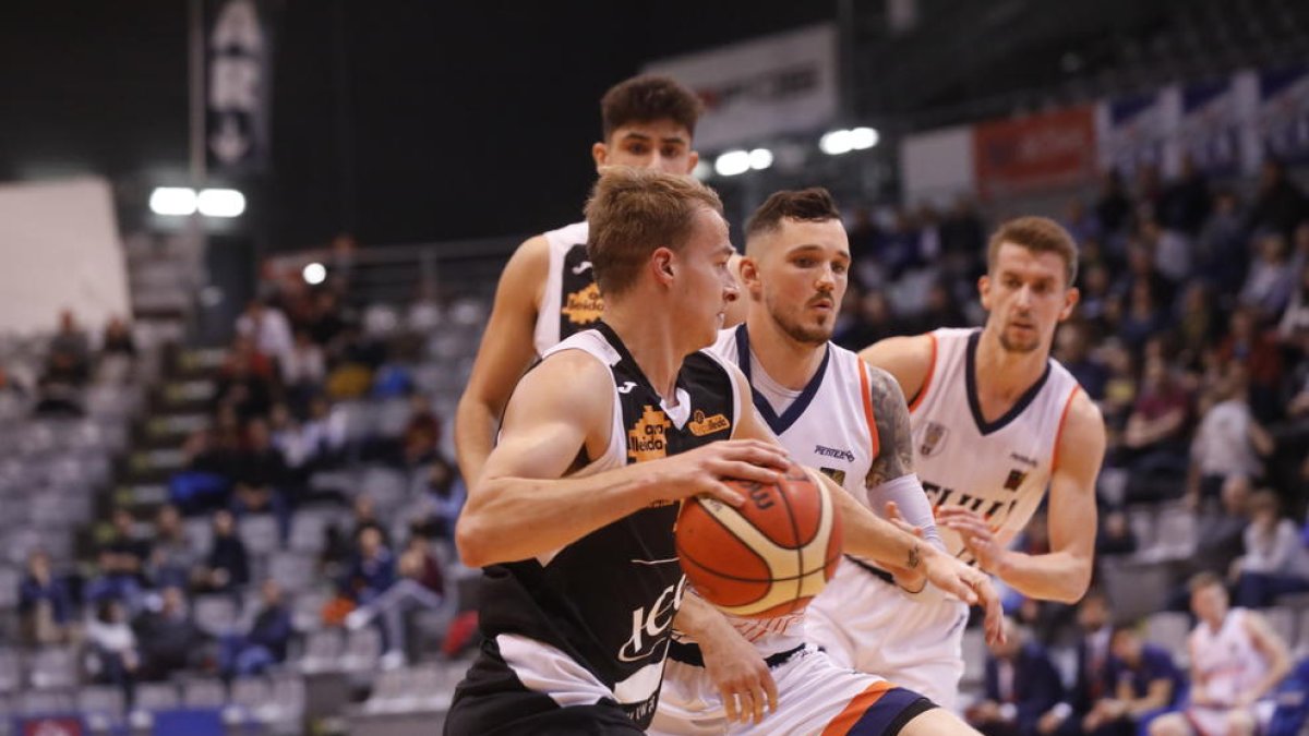 Steve Santa Ana conduce el balón ante Andris Misters.