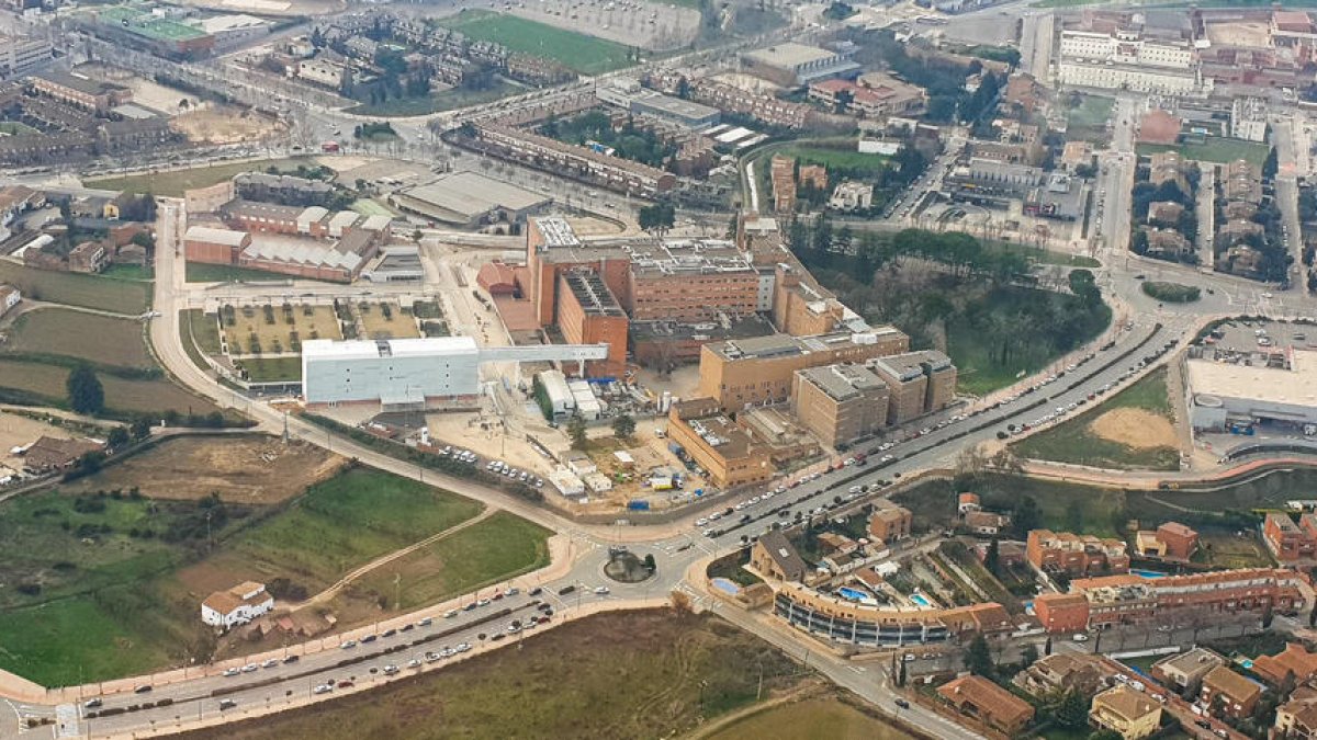 Imatge aèria de l’hospital Arnau i del nou edifici i la passarel·la de connexió, de color blanc.