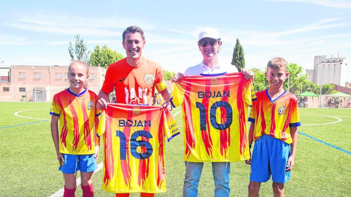 Bojan hijo y padre, con camisetas de la Escuela de Fútbol Bellpuig.