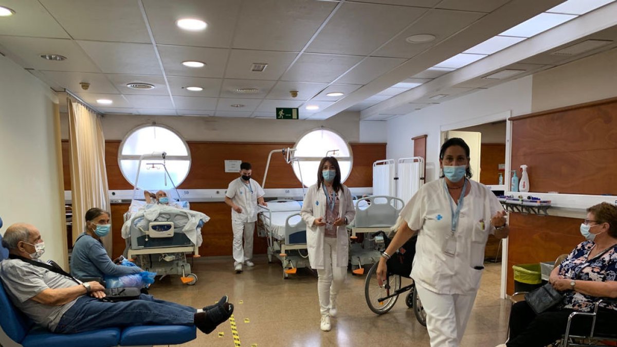 Personal de l’Arnau i pacients esperant a la sala per tornar al seu domicili en ambulància.