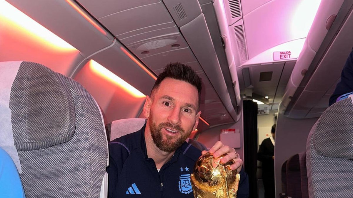 Leo Messi, con la copa del Mundial en el interior del avión de vuelta a Argentina.