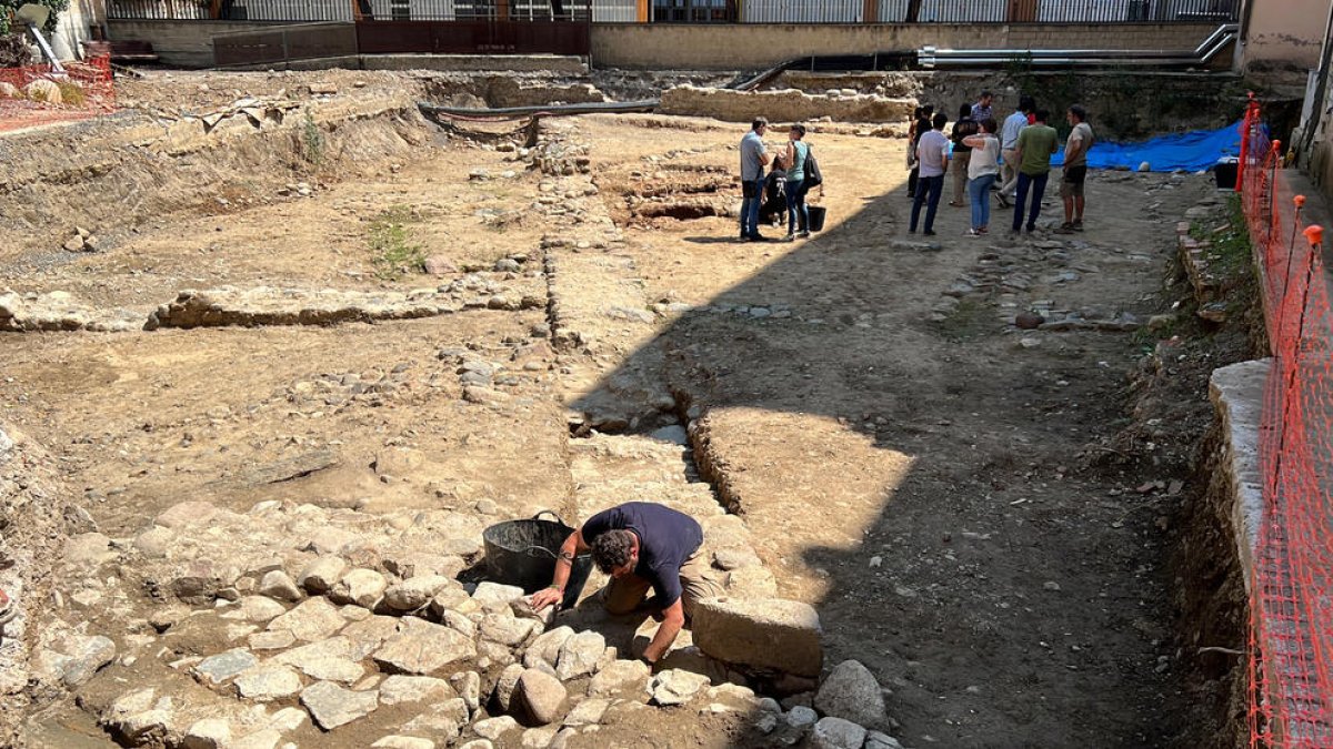 Un arqueólogo trabajando en la zona donde se ha localizado parte de una torre de la muralla de la Seu d'Urgell, en el yacimiento de Les Monges.