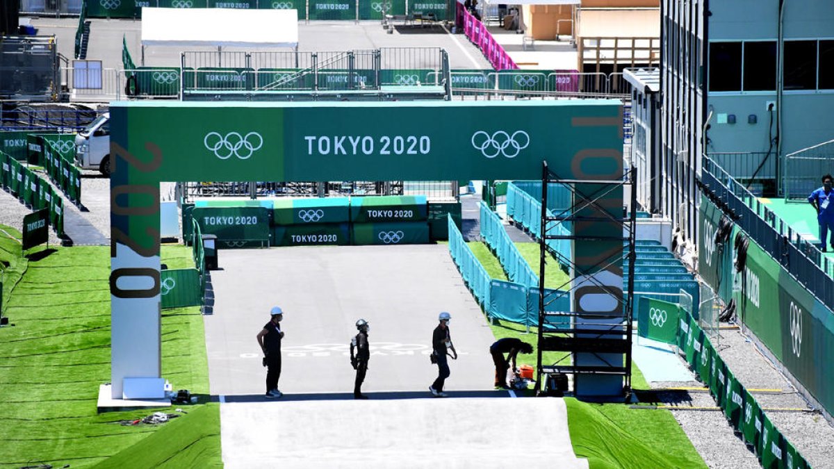 Operarios japoneses ultiman los preparativos ayer en los aledaños del estadio nacional de Tokio.