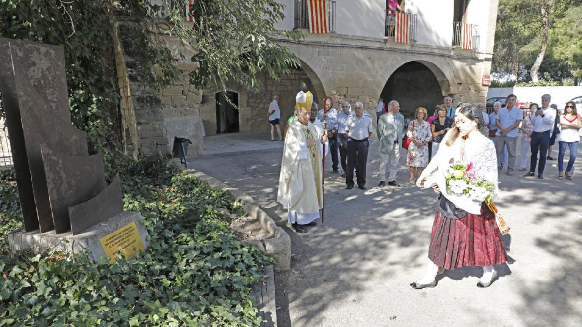 Ofrena floral ahir a càrrec de la pubilla de Butsènit abans de la missa oficiada pel bisbe de Lleida.