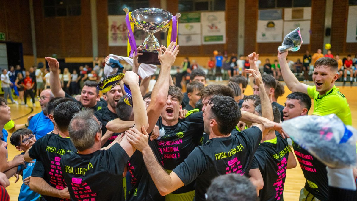 Els jugadors del Futsal Lleida celebren l’ascens de categoria amb la copa de campions.