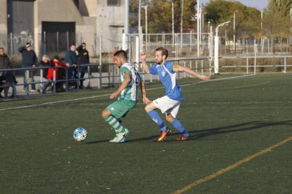 Un jugador del Magraners intenta protegir la pilota en una jugada del partit.