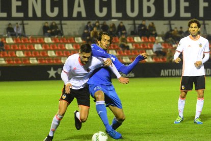 Fran Moreno, que estuvo desafortunado en la línea general del equipo, lucha por el balón con un defensa del Valencia Mestalla.