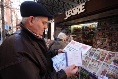 Un lector compra el diario SEGRE en un quiosco.