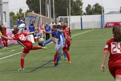 Una jugadora de l’AEM intenta controlar una pilota davant de la pressió d’una rival.