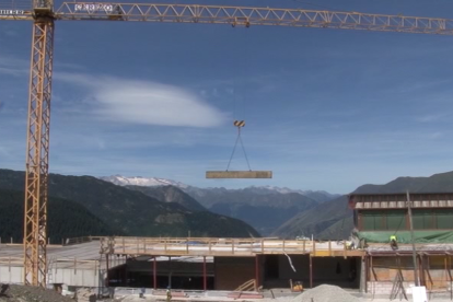 Una grúa transportando los materiales para la construcción.