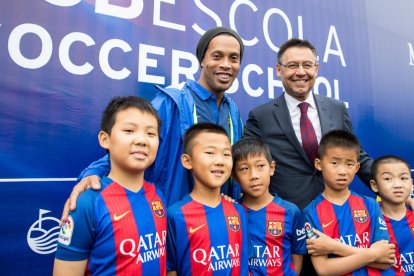 Ronaldinho i Bartomeu al costat de nens de l’illa xinesa de Hainan.