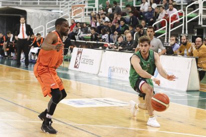 Guillermo Corrales da un pase ante la defensa de Jarred Ogungbemi, que volvió a ser el máximo anotador y el líder de un equipo que sigue sin reaccionar.