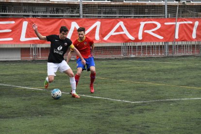 El capità de l’Alpicat controla la pilota davant la pressió d’un jugador del Martinenc.