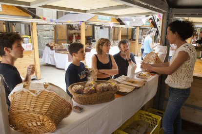 Visitants ahir en un dels expositors que han participat a la Fira del Pa de Cervera.