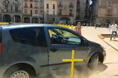 Imagen del coche arrollando varias cruces amarillas.