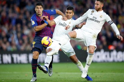 Luis Suárez, que va ser un malson per a la defensa madridista, pugna per la pilota amb Casemiro i Sergio Ramos.