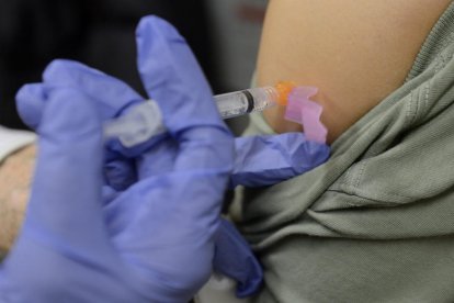 Una mujer recibe una vacuna contra la gripe. 