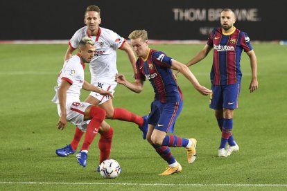 Frenkie de Jong disputa una pilota amb un rival sevillista.