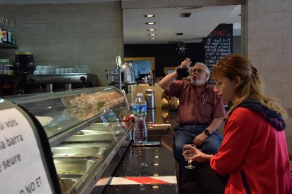 La barra d’un bar amb l’espai delimitat amb cinta adhesiva a la Seu d’Urgell (esquerra) i un establiment amb la barra també oberta a Sort.