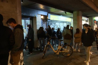 Numerosos jóvenes reunidos celebrando una fiesta en la calle.