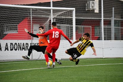 Hamza, del Alpicat trata de rematar a gol ante la oposición de Adrià y de Calderó, del Angulària.