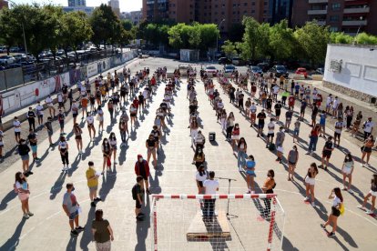 Els alumnes d’un institut de Tarragona, durant la presentació del curs escolar al pati, amb mascareta i guardant les distàncies.