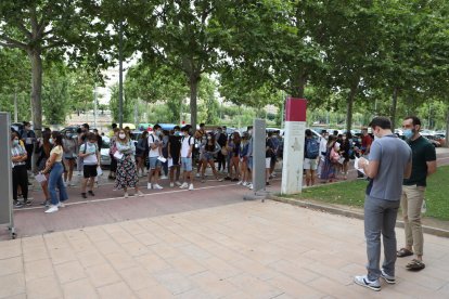 Un grupo de alumnos escucha las indicaciones de los profesores antes de entrar en el aula a hacer las pruebas de aptitud personal (PAP). 