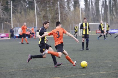 Un jugador del Pinyana intenta controlar el balón ante un defensor del Pardinyes.