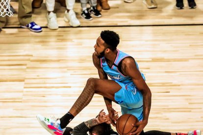 Derrick Jones supera a dos voluntarios en uno de sus mates.