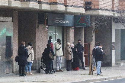 Ciudadanos haciendo cola ante un laboratorio.