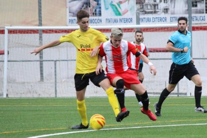 Un jugador del Mollerussa defiende el balón ante un rival en una acción del partido.