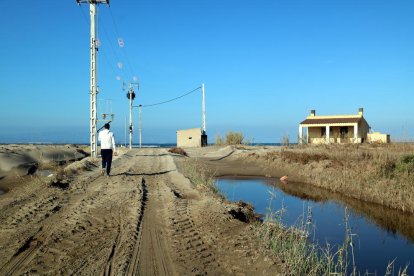 Un agricultor pasea por uno de sus campos de arroz que quedó anegado por el temporal.