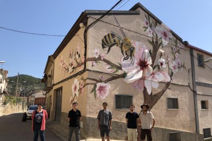 La alcaldesa de Os de Balaguer, el gerente de Torrons i Mel Alemany y los tres artistas ante el mural.