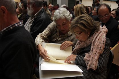 Dos mujeres revisan los 'papeles de Salamanca' recuperados, en el acto de entrega del 3 de diciembre de 2015.